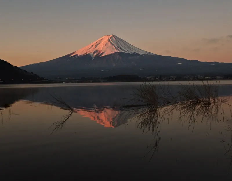 Mt Fuji glowing pink at dawn, reflected in Lake Kawaguchi