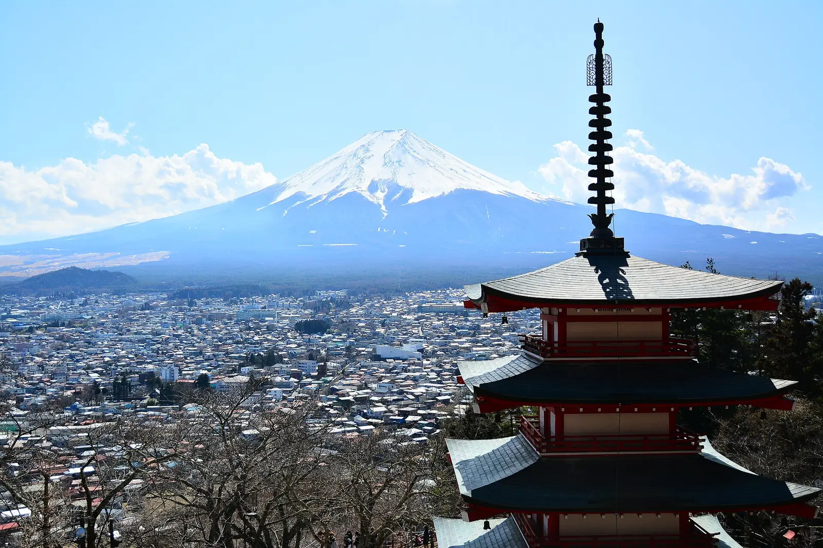 Snow-covered Mt Fuji above Fujiyoshida town, the top of Chureito Pagoda in front