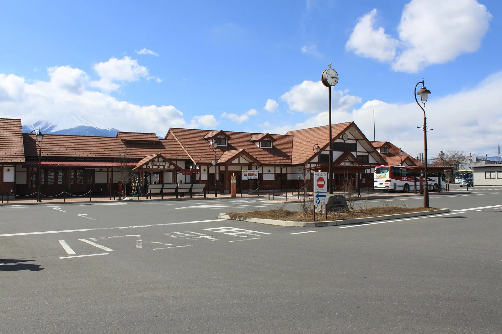 Kawaguchiko Station front under a blue sky, Mt Fuji peak at left
