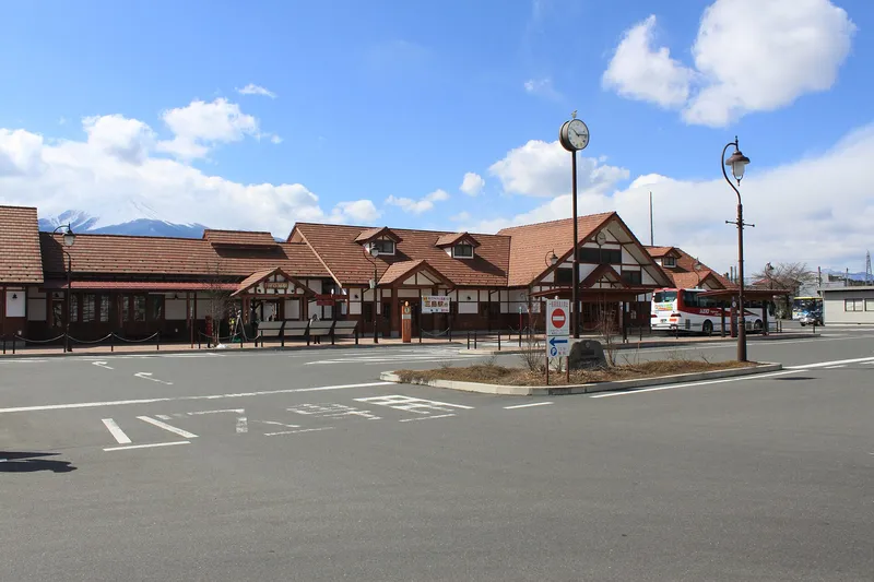 Kawaguchiko Station front under a blue sky, Mt Fuji peak at left