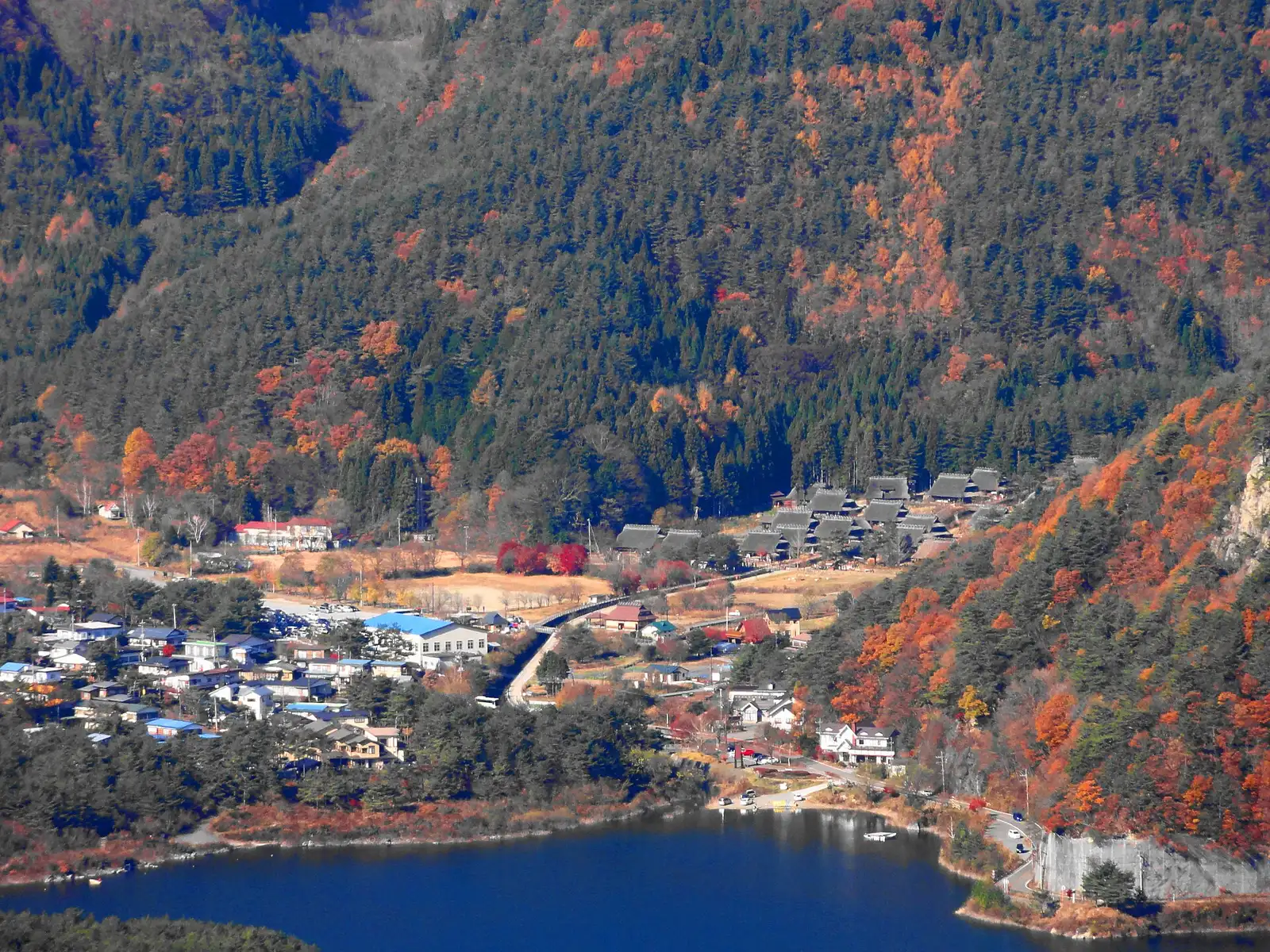 Iyashi no Sato Nenba village from above in autumn, Lake Saiko beyond