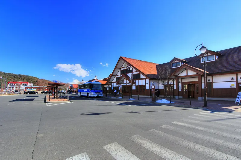 Wide view of Kawaguchiko Station under a deep blue sky