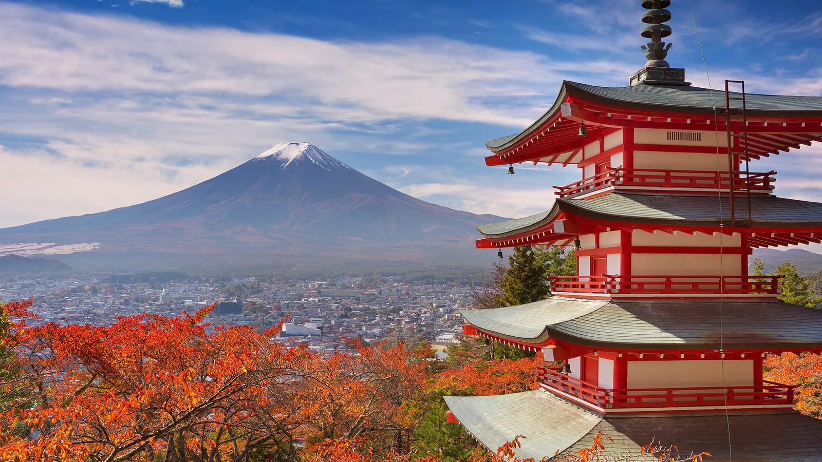 Chureito Pagoda with red autumn leaves, Mt Fuji and Fujiyoshida town behind