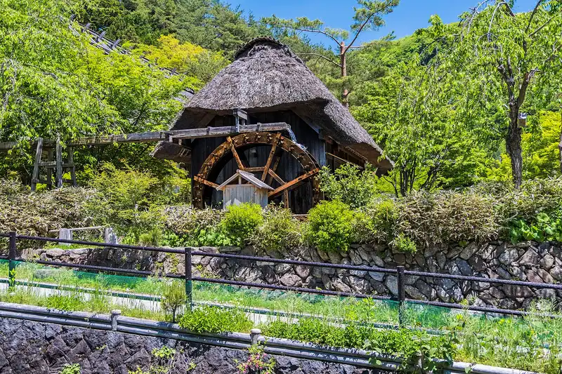 Thatched water-mill hut with a wooden wheel at Iyashi no Sato Nenba